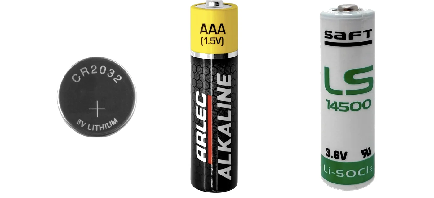 Three cells side by side, not to scale. A CR2032 lithium coin cell marked 3 volts. An AAA alkaline cell marked 1.5 volts. A Saft LS14500 lithium thionyl chloride cell in AA size marked 3.6 volts.