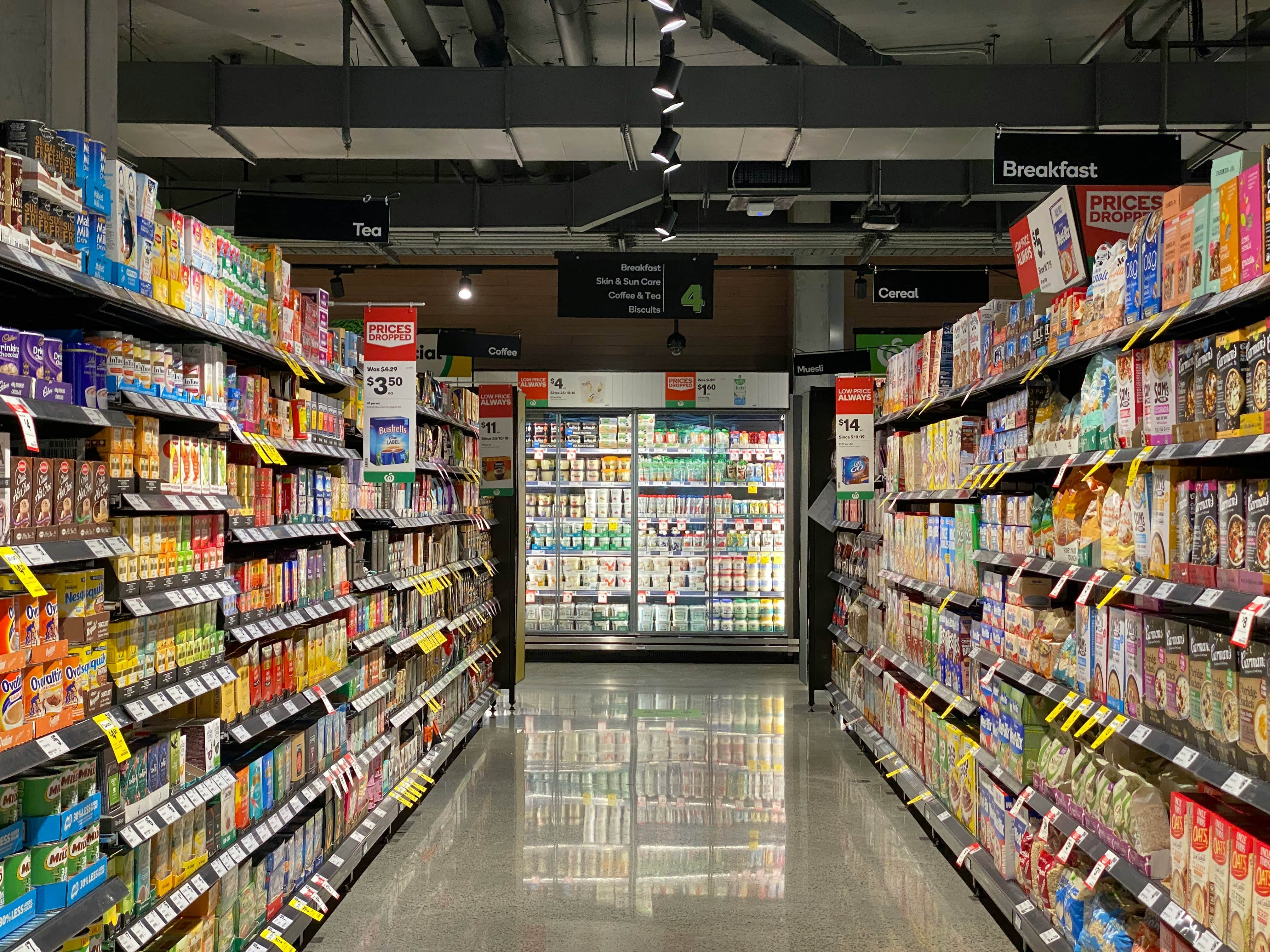 Grocery store aisle with refrigerated cases